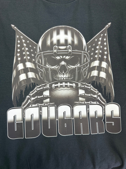 Black t-shirt with a graphic design of a skull in a football helmet with American flags and the word 'COUGARS'.